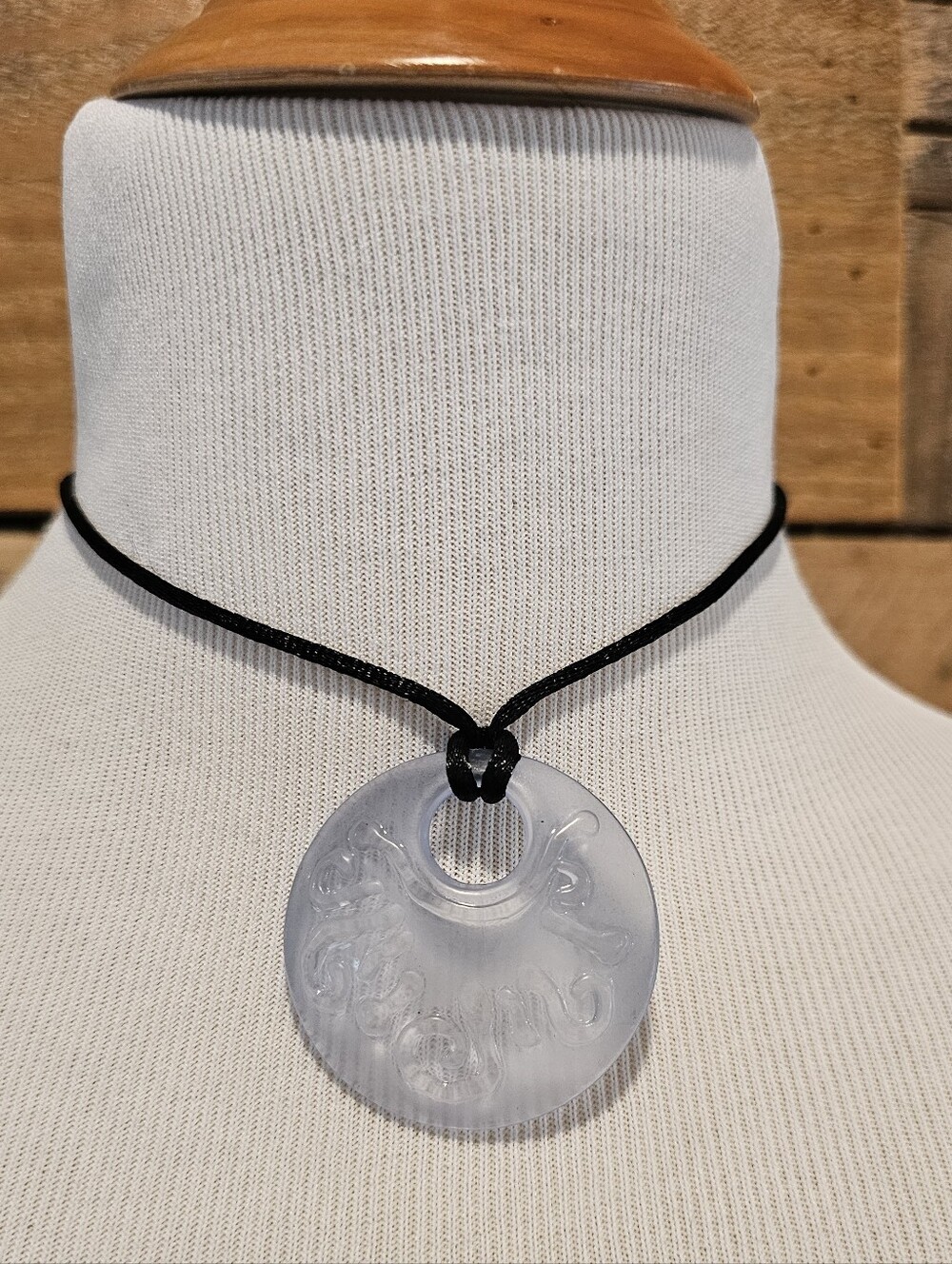 Frosted Clear Round Pendant Necklace With Swirl Motif on Adjustable Black Cord